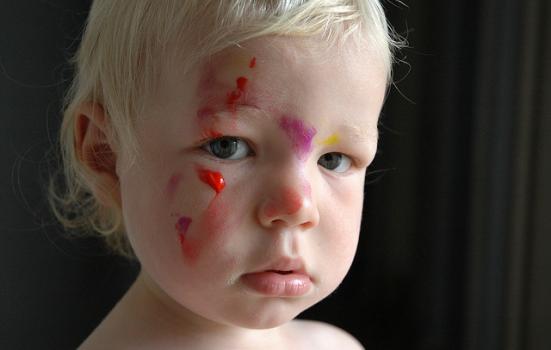 Photo of a child with paint on his face