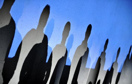 Photo of human shapes against blue sky