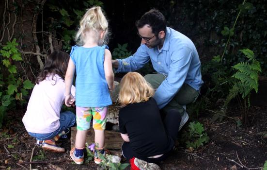 Adam Cooper with some children examining the earh