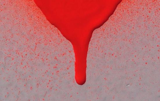 Red paint dripping down a canvas
