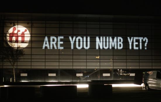 Projection of "Are you numb yet?" onto a building