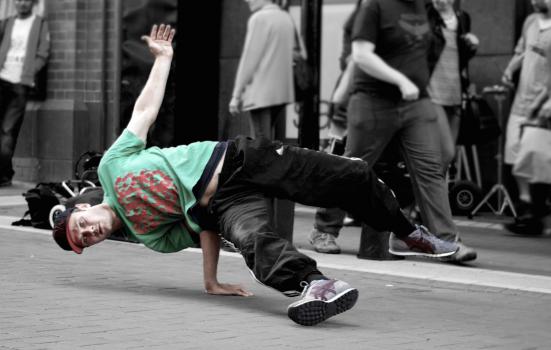 Photo of break dancer performing on street
