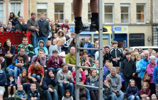 a crowd watching a street performance in Edinburgh