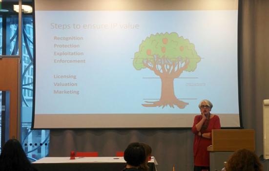 Photo of Ruth Soetendorp presenting in front of an image of a tree
