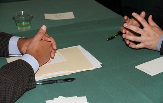 Image of hands of interviewer and interviewee