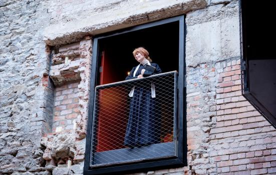 Photo of actress looking down from balcony