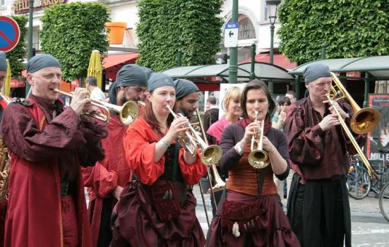A photo of people dressed as pirates playing brass instruments