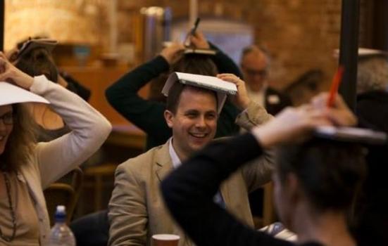 Image of people with paper on heads