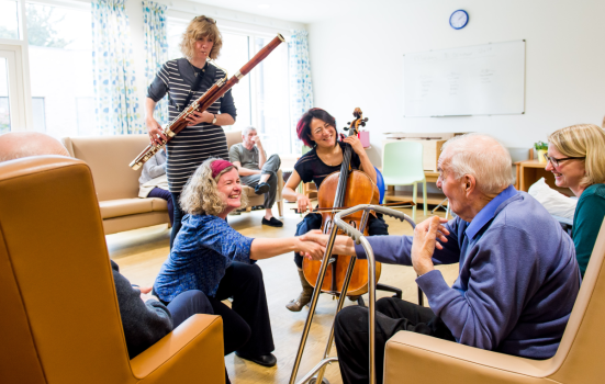Musicians playing to patients in a care settting