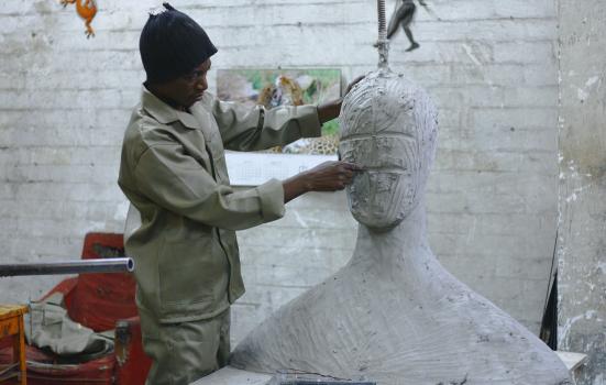 Man working on his sculpture