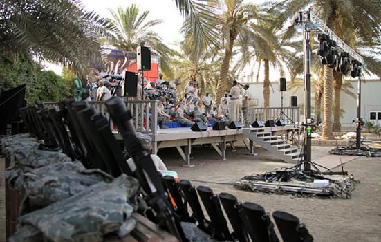 US troops performing on an outdoor stage at an undisclosed location