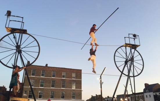 Photo of tightrope walkers in city street