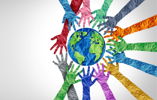 Colourful hands encircling a paper globe on a white backdrop, symbolising diverse cultures and international cooperation.