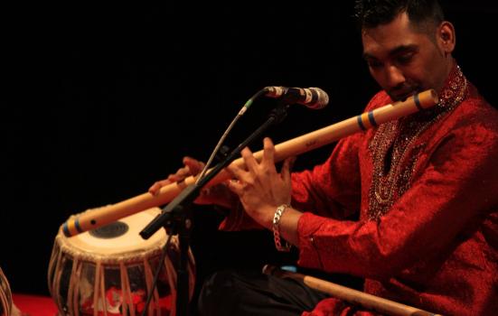 Photo of a man playing the bansuri flute