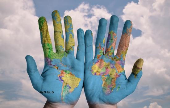 Photo of hands with world map on