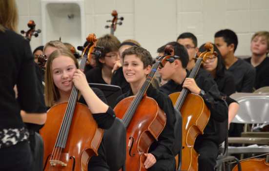 a group of students play the cello