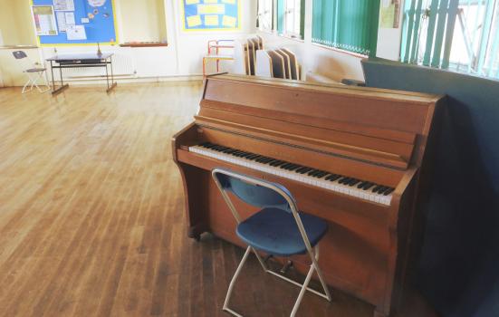 A piano in a school hall
