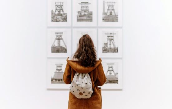 Young woman looking at images in a gallery