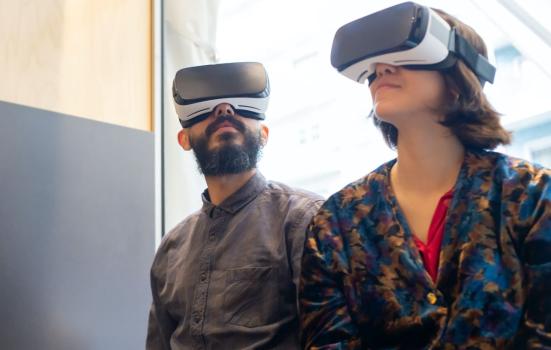 A man and woman wearing virtual reality headsets