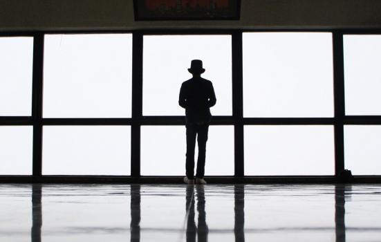 Photo of man standing by window