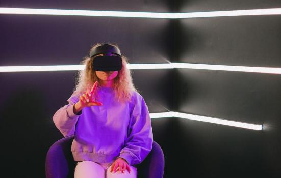 A seated woman using a VR headset