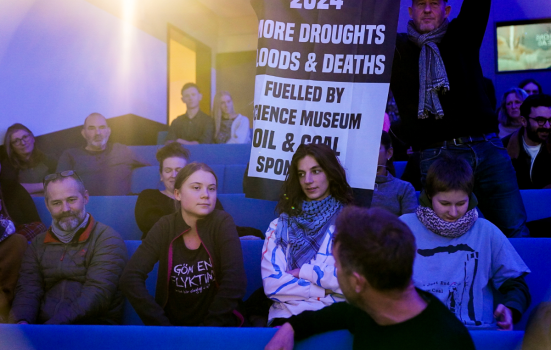 Protesters sitting in on a panel debate organised by the Science Museum