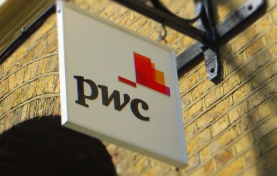 The PricewaterhouseCoopers logo hanging from the side of a building