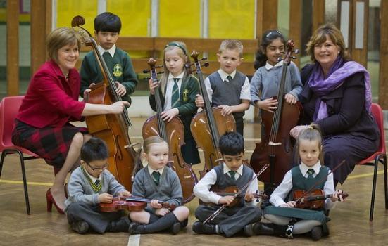 Photo of children with instruments, with Nicola Sturgeon & Fiona Hyslop