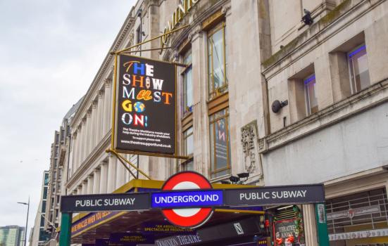 London tube station with Show Must Go On poster above