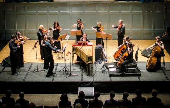 Ensemble of players on stage watched by audience