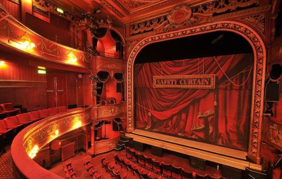 The interior of Theatre Royal Stratford East showing the stage with the safety iron down
