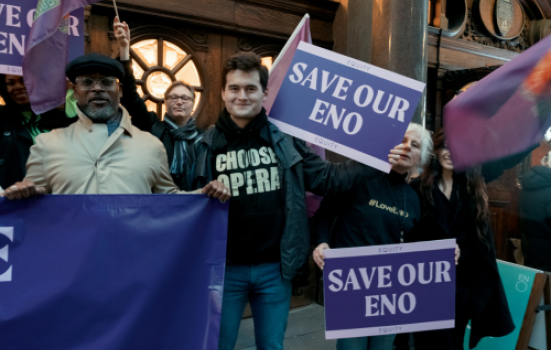 Protesters outside The Coliseum hold purple placards reading 'Save our ENO'