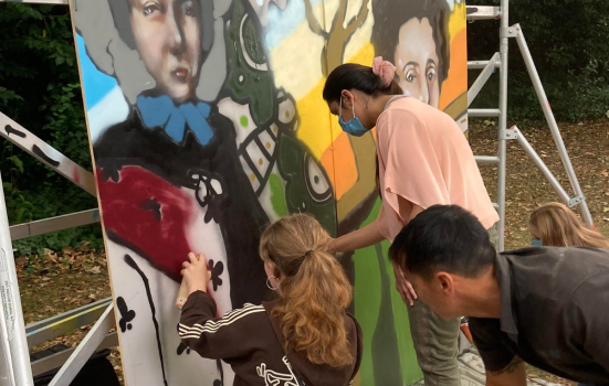 Young people working on graffitti