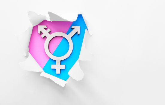 Symbol of transgender symbol visible through torn paper on a pink and blue background