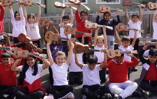 Pupils at Hallsville Primary School hold their ukuleles
