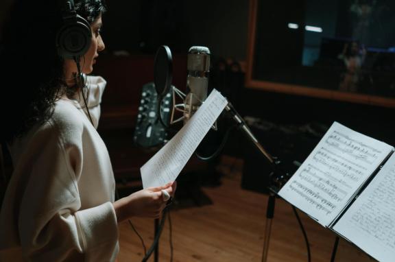A woman singing in a recording studio
